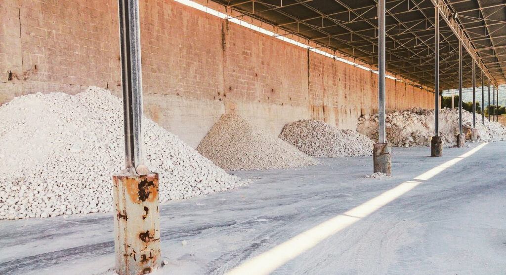 Piles of raw limestone under cover